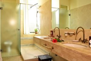 a bathroom with a sink and a mirror at Hotel Costa dei Fiori in Santa Margherita di Pula