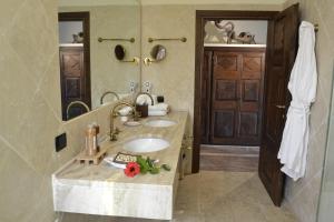 a bathroom with a sink and a mirror at Hotel Costa dei Fiori in Santa Margherita di Pula