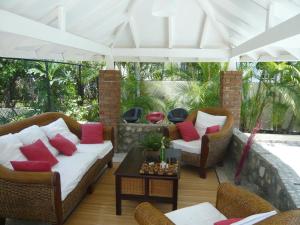 a patio with two couches and a table at Villa Los Almendros - 2 pools and private tennis court in Baní