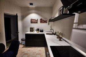 a kitchen with a sink and a counter top at Metropole Apartments Royal Residence in Bucharest