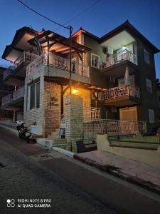 a large brick house with two balconies on a street at Villa Maria in Sarti