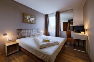 
Ein Bett oder Betten in einem Zimmer der Unterkunft Hotel Leipzig West

