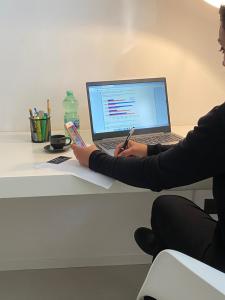 a person sitting at a desk with a laptop computer at Residenza Pantaleo in Rome