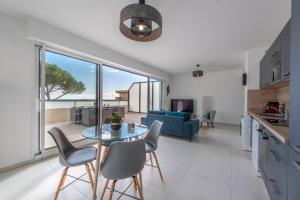 a kitchen and living room with a table and chairs at Elegance in Nice