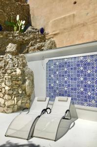a bench in front of a blue tile on a wall at Marilù vacation home in Positano in Positano