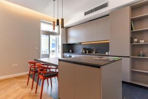 a kitchen with a black counter top and a table at Apartment La Marie in Split