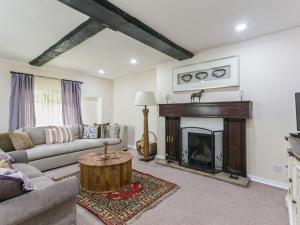 a living room with a couch and a fireplace at Historically Charming Home with Large Garden- Pass the Keys in Burnham