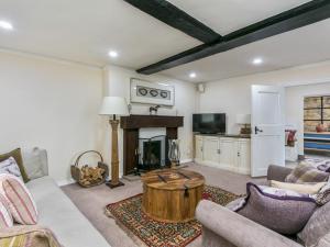 a living room with a couch and a coffee table at Historical Cottage Escape BIG in Burnham