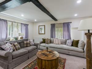 a living room with a couch and a table at Historically Charming Home with Large Garden- Pass the Keys in Burnham
