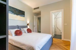a bedroom with a large white bed with red pillows at Apartment La Marie in Split