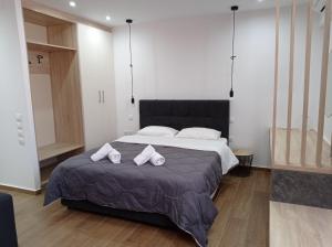 a bedroom with a bed with two towels on it at VH Executive Suites in Thessaloniki