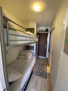 a small room with two bunk beds and a rug at Boost Your Immo Le Villaret Risoul 377 in Risoul