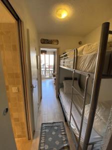 a hallway with two bunk beds in a room at Boost Your Immo Le Villaret Risoul 377 in Risoul