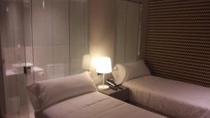 Postel nebo postele na pokoji v ubytování Hotel Atalaia
