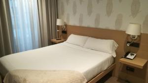 Postel nebo postele na pokoji v ubytování Hotel Atalaia