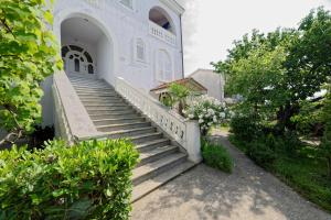 a set of stairs leading to a building at Apartments Udovicic HH in Medulin