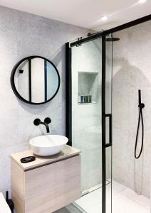 a bathroom with a sink and a shower at The Lookout in Swanage