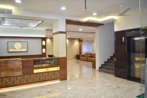 a lobby of a hotel with a staircase and a living room at Bhramari Nest in Subrahmanya