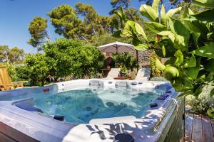 a jacuzzi tub in a backyard with trees at Villa Karina - Unique location with jacuzzi in Split