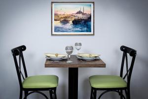 a table with two chairs and a picture on the wall at Zeyn Otel Istanbul in Istanbul