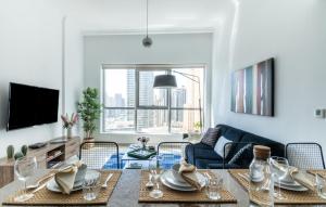 a living room with a table and a couch at The Smart Concierge - Bay Central in Dubai