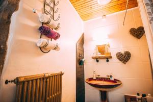 a bathroom with a sink and a towel rack at Wool Combers Rest & Brönte Parsonage - Haworth in Haworth