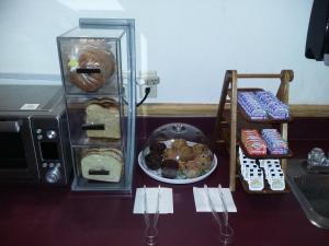 a table with a plate of pastries and a microwave at Pleasant Moose Lodge in Newberry