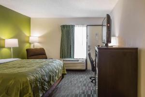 a hotel room with a bed and a television at Quality Inn in Culpeper