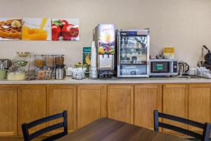 a kitchen counter with a refrigerator and a microwave at Quality Inn in Culpeper