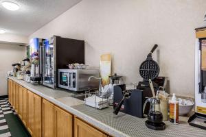 a kitchen with a counter top with a microwave at Quality Inn in Culpeper
