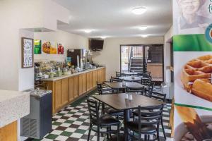 a restaurant with tables and chairs and a counter at Quality Inn in Culpeper
