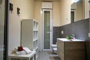 a bathroom with a sink, toilet, and cabinet at Residence Felice in Celle Ligure