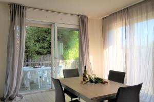 a dining room table with chairs and a window at Residence Felice in Celle Ligure