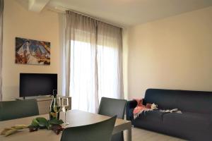 a living room with a blue couch and a table at Residence Felice in Celle Ligure