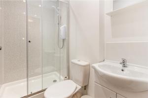 a bathroom with a shower and a toilet and a sink at Guest Homes - The Foregate in Worcester