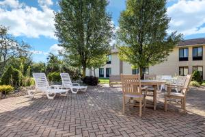 a group of chairs and a wooden table and chairs at Quality Inn Dover in Dover