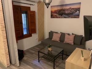 een woonkamer met een bank en een tafel bij AnDiMi Pozo Chico in Toledo