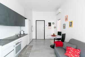 a kitchen and living room with a couch and a table at Marconi Dreams in Bologna