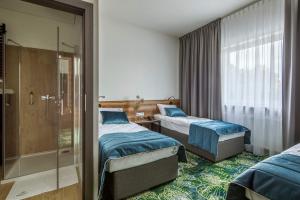 Postel nebo postele na pokoji v ubytování Bloom Hotel Airport Okęcie + 19 fotografií