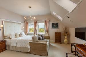 a large bedroom with a bed and a couch at Dún Ard in Dungarvan