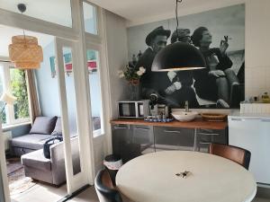 a kitchen with a white table in a room at Loren & Fellini in Zandvoort