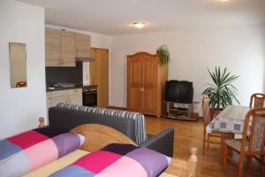 a living room with a couch and a table at Pension & Ferienwohnung Breitmoser Angelika in Riedenburg
