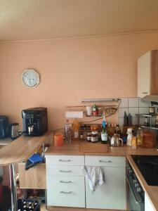 a kitchen with a counter and a clock on the wall at Haus am Donatsturm in Freiberg