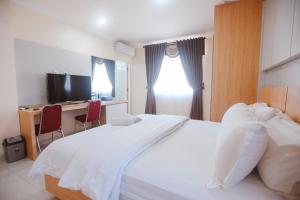 מיטה או מיטות בחדר ב-CHRYSANT HOTEL & RESORT