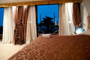 A bed or beds in a room at Grand Ambiance Hotel