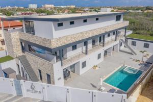 an aerial view of a building with a swimming pool at Gray Door Apartments - Adults only in Palm-Eagle Beach