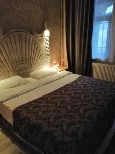 a large bed in a bedroom with a window at tulpar hotel in Urgup