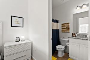 a white bathroom with a toilet and a sink at Gabrielle Townhomes in Boise +76 photos