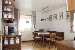 a kitchen with a table and chairs in a room at Ferienhaus Betty in Selbitz
