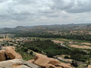 a view of a city from a mountain with rocks at Hotel Varsha Hampi in Hampi